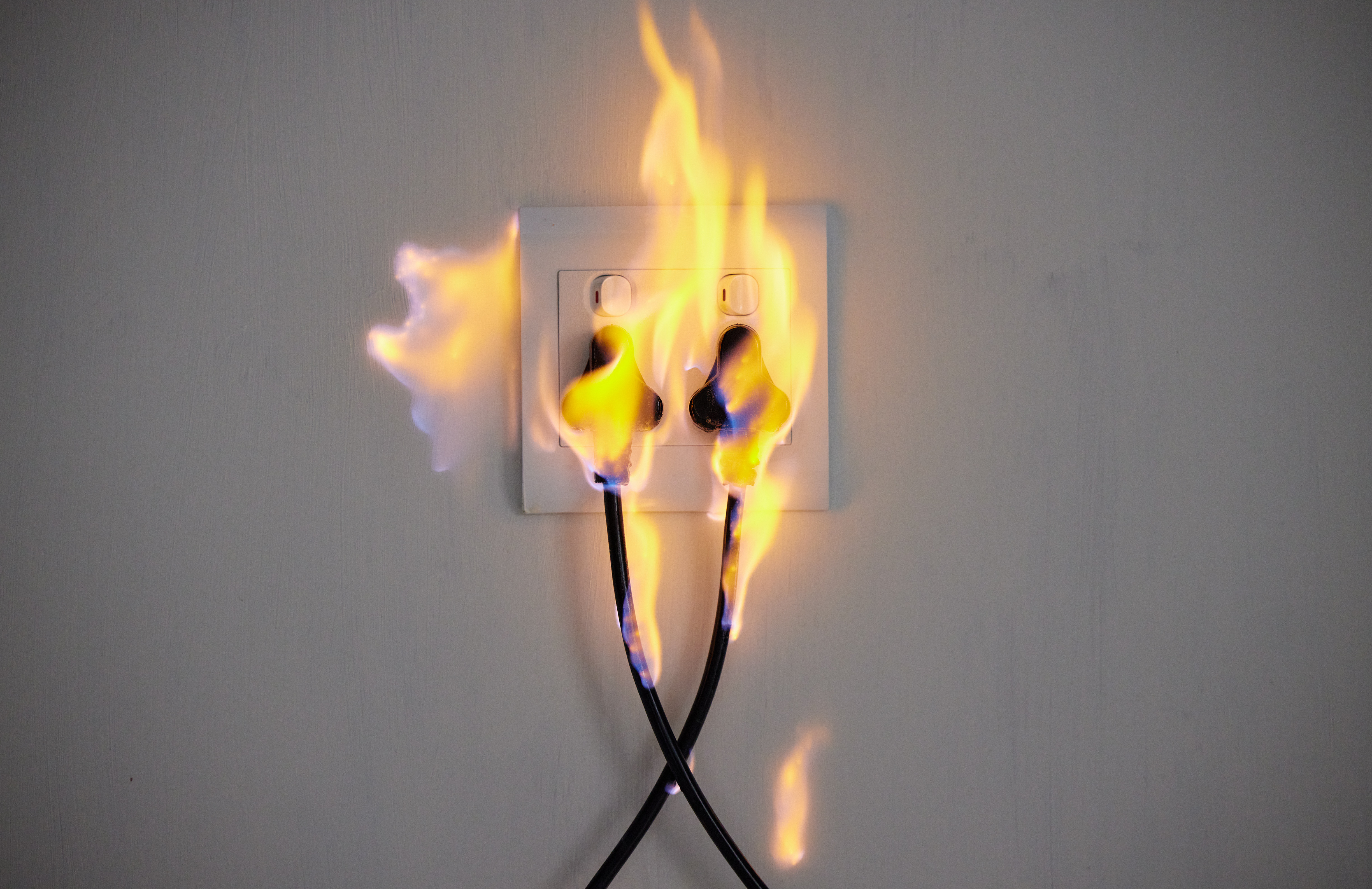 47561446_electrical-fire-two-plugs-in-a-wall-socket-catching-fire
